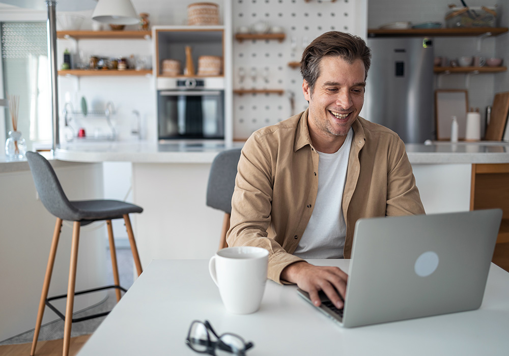 man on laptop working from home