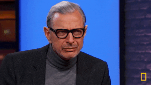 Jeff Goldblum lifting his hand to his chin in thought.