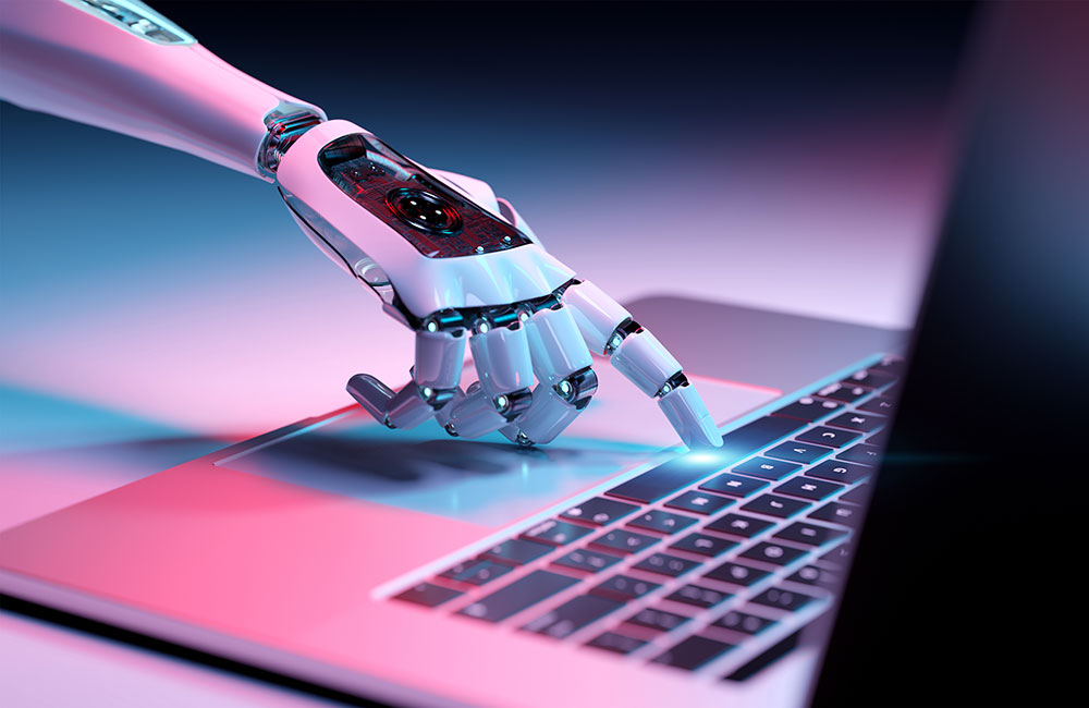 Robot hand clicking a laptop.